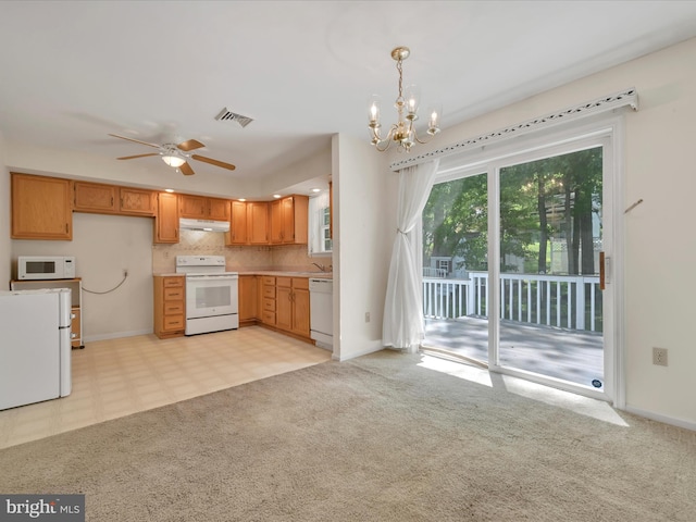 95 Comanche Dr, Auburn, PA 17922 - kitchen featuring white appliances, under cabinet range hood, a chandelier, ceiling fan, and light countertops