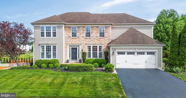 3 Graham Ct, Middletown, DE 19709 - view of front facade with a garage, a front yard, stone siding, driveway, and a shingled roof