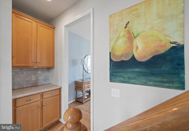 3 Graham Ct, Middletown, DE 19709 - kitchen featuring decorative backsplash, light countertops, brown cabinetry, and baseboards