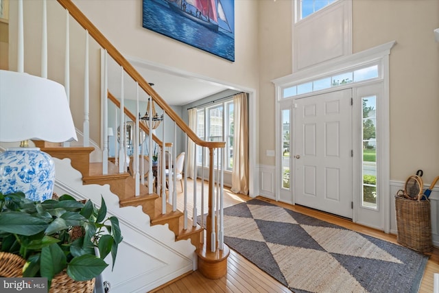 3 Graham Ct, Middletown, DE 19709 - foyer with stairway, a wainscoted wall, wood finished floors, a decorative wall, and a high ceiling