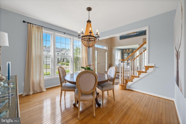 3 Graham Ct, Middletown, DE 19709 - dining room with a chandelier, baseboards, light wood finished floors, and stairway