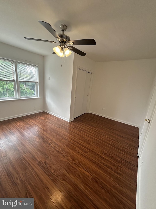 6637 Malvern Ave, Philadelphia, PA 19151 - unfurnished room featuring dark wood-style flooring, ceiling fan, and baseboards