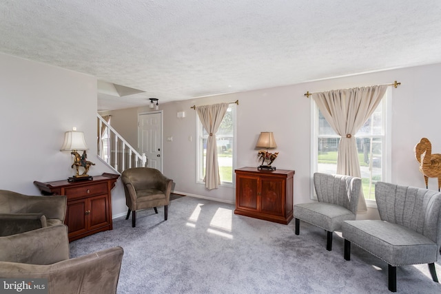 10263 Wayover Way, Columbia, MD 21046 - living area with light colored carpet, stairs, a textured ceiling, and baseboards