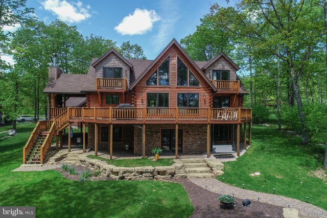 90 Biltmore Ridge Trl, Mc Henry, MD 21541 - back of house with a balcony, log siding, a patio area, stone siding, and a lawn