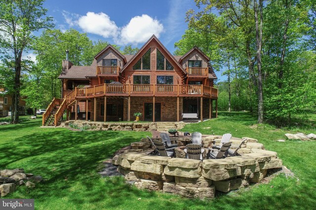 90 Biltmore Ridge Trl, Mc Henry, MD 21541 - back of property featuring a fire pit, a yard, stairway, and a wooden deck