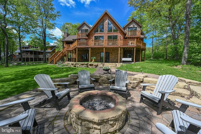 90 Biltmore Ridge Trl, Mc Henry, MD 21541 - rear view of property featuring a fire pit, a patio area, a lawn, a deck, and stone siding