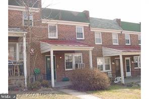 1309 W 37th St W, Baltimore, MD 21211 - townhome / multi-family property featuring brick siding and covered porch