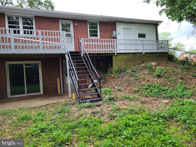 5900 Arbroath Dr, Clinton, MD 20735 - back of property featuring brick siding, a wooden deck, and stairway