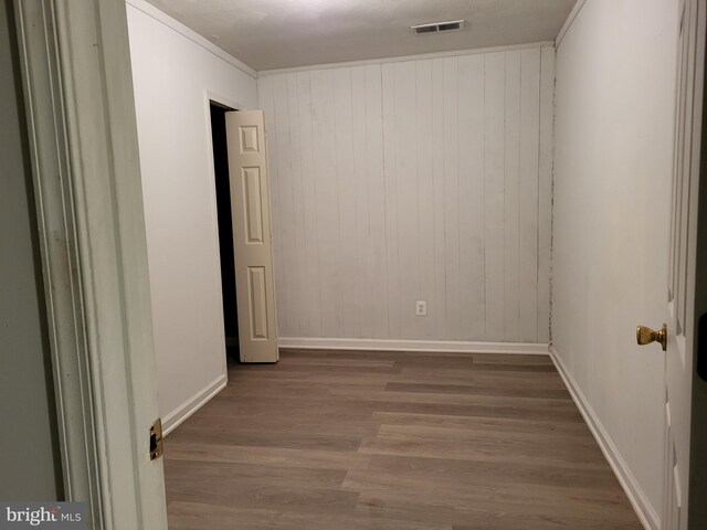 5900 Arbroath Dr, Clinton, MD 20735 - unfurnished room featuring wood finished floors, baseboards, and wood walls