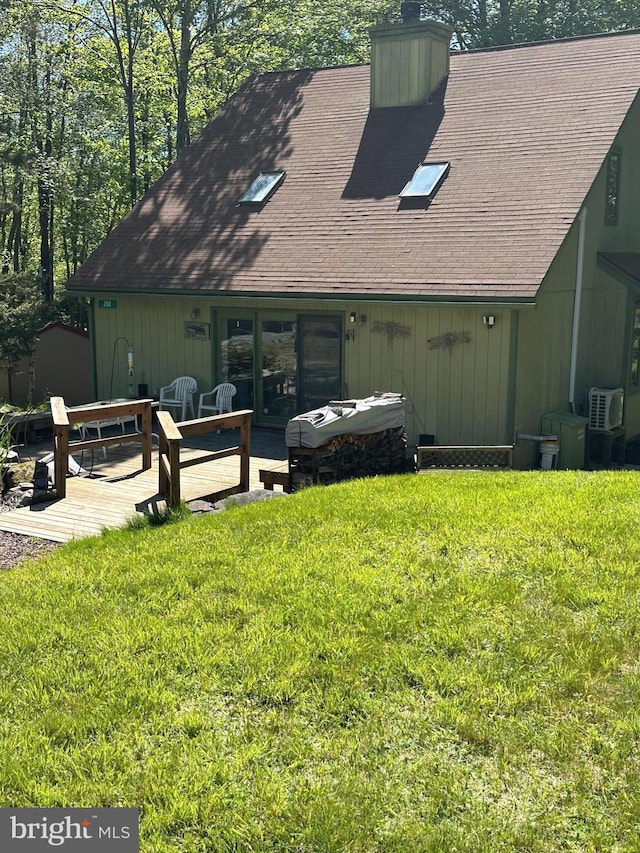 202 Tepee Dr, Pocono Lake, PA 18347 - back of property featuring a chimney, a lawn, a storage unit, and a shingled roof