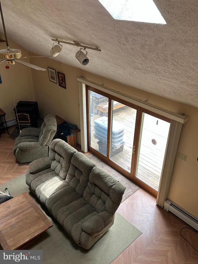 202 Tepee Dr, Pocono Lake, PA 18347 - living room featuring a textured ceiling, a baseboard heating unit, and ceiling fan