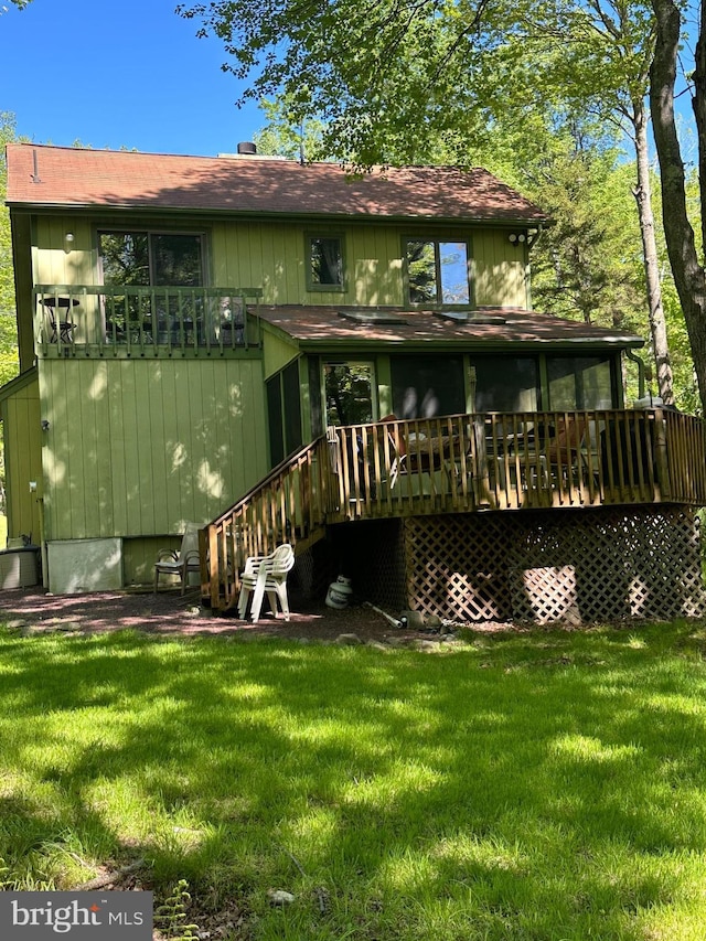 202 Tepee Dr, Pocono Lake, PA 18347 - rear view of house with a lawn, a deck, and a shingled roof