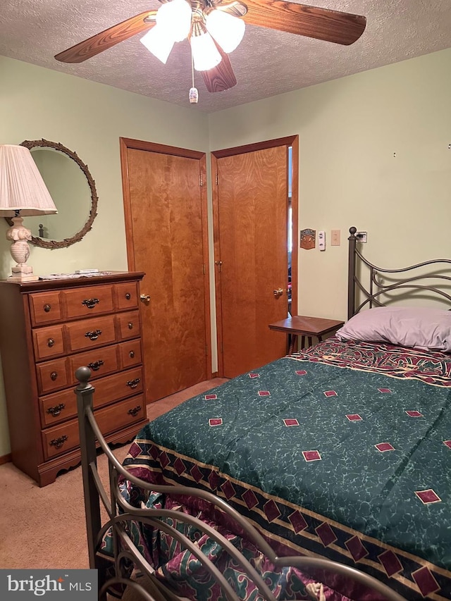 202 Tepee Dr, Pocono Lake, PA 18347 - bedroom featuring a textured ceiling, light colored carpet, and a ceiling fan
