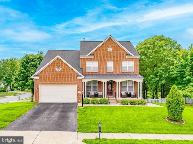 4141 Philena St, Dumfries, VA 22025 - traditional home featuring a porch, a garage, brick siding, asphalt driveway, and a shingled roof