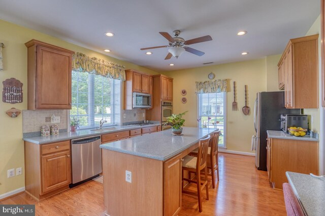 29865 Hillary Ave, Easton, MD 21601 - kitchen with stainless steel appliances, a kitchen island, ceiling fan, decorative backsplash, and recessed lighting