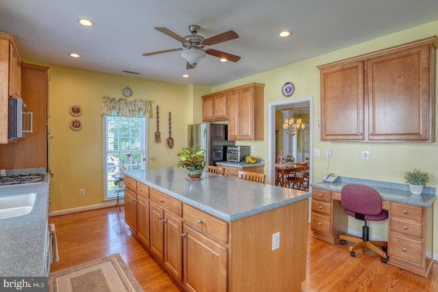 29865 Hillary Ave, Easton, MD 21601 - kitchen featuring a ceiling fan, an office area, a kitchen island, light wood finished floors, and stainless steel microwave