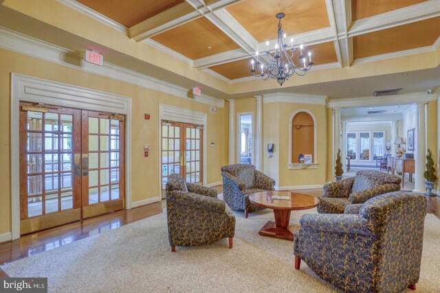 29865 Hillary Ave, Easton, MD 21601 - living area featuring ornate columns, crown molding, coffered ceiling, french doors, and a chandelier