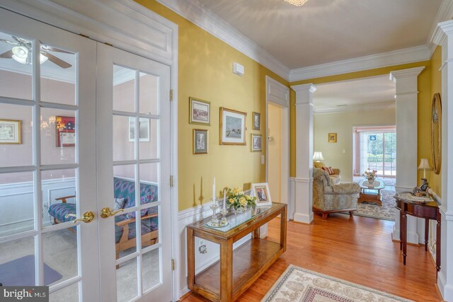 29865 Hillary Ave, Easton, MD 21601 - doorway to outside with ornate columns, light wood-type flooring, a ceiling fan, and ornamental molding