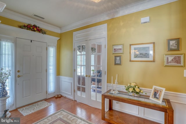 29865 Hillary Ave, Easton, MD 21601 - entrance foyer with healthy amount of natural light, a wainscoted wall, wood finished floors, ornamental molding, and french doors