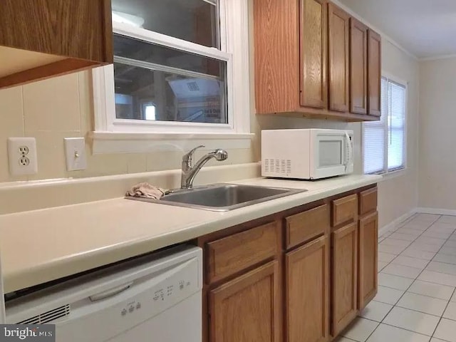 7602 Old Linton Hall Rd, Gainesville, VA 20155 - kitchen featuring white appliances, a sink, light tile patterned flooring, crown molding, and light countertops
