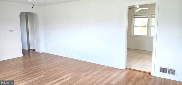 7602 Old Linton Hall Rd, Gainesville, VA 20155 - empty room with a ceiling fan, arched walkways, wood finished floors, and baseboards