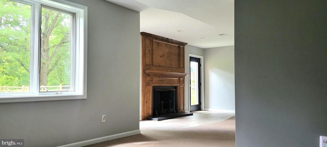 4 E Spring Oak Cir, Media, PA 19063 - unfurnished living room featuring healthy amount of natural light, a large fireplace, baseboards, and carpet flooring