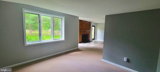 4 E Spring Oak Cir, Media, PA 19063 - unfurnished room featuring baseboards, light carpet, and a fireplace with raised hearth