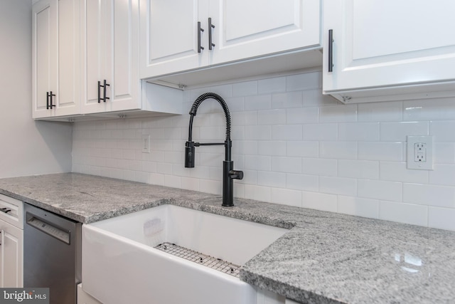 351 Doone Rd, Fairless Hills, PA 19030 - kitchen featuring stainless steel dishwasher, a sink, backsplash, and white cabinetry