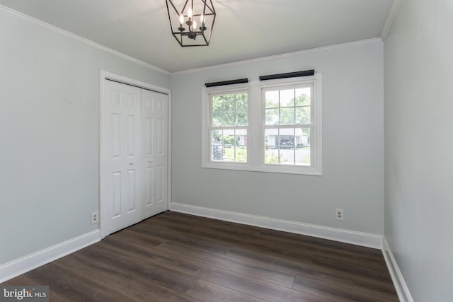 351 Doone Rd, Fairless Hills, PA 19030 - unfurnished bedroom with dark wood finished floors, a chandelier, ornamental molding, baseboards, and a closet