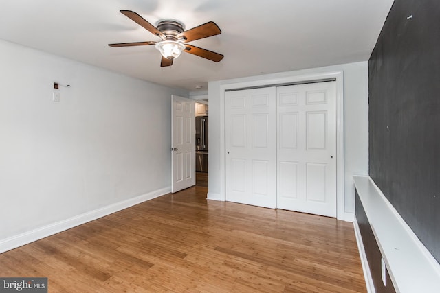 351 Doone Rd, Fairless Hills, PA 19030 - unfurnished bedroom featuring light wood-type flooring, a closet, baseboards, a ceiling fan, and stainless steel refrigerator with ice dispenser