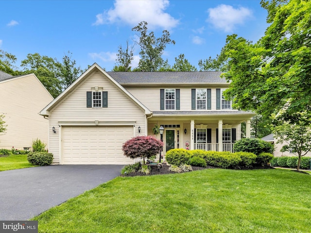 6469 Saddlebrook Ln, Frederick, MD 21701 - view of front of house with asphalt driveway, covered porch, a front lawn, and a garage