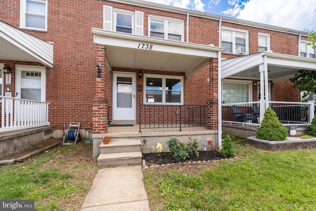 1738 Stokesley Rd, Baltimore, MD 21222 - view of exterior entry with a porch, brick siding, and a lawn