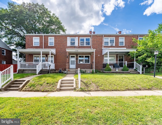 1738 Stokesley Rd, Baltimore, MD 21222 - multi unit property featuring a porch, brick siding, a front yard, and a chimney