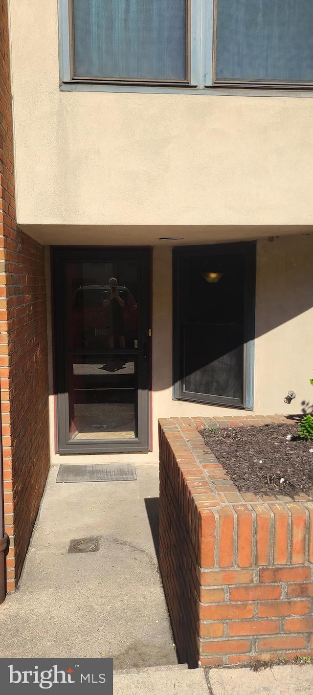 214 N 22nd St N Unit Dr11L, Philadelphia, PA 19103 - doorway to property featuring stucco siding and brick siding