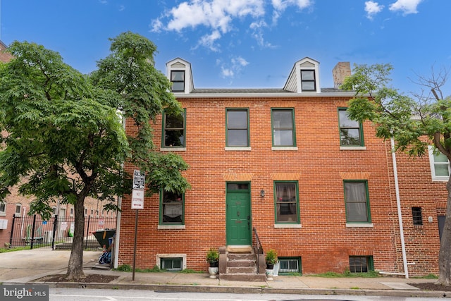 503 N Paca St, Baltimore, MD 21201 - view of property with entry steps, brick siding, and a chimney