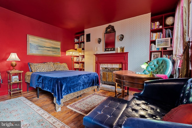 503 N Paca St, Baltimore, MD 21201 - bedroom featuring wood finished floors, a fireplace, and wallpapered walls