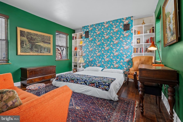 503 N Paca St, Baltimore, MD 21201 - bedroom with an accent wall, wood finished floors, and baseboards