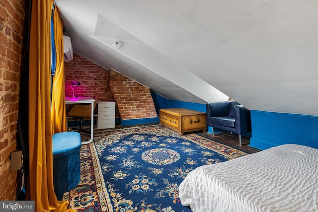 503 N Paca St, Baltimore, MD 21201 - bedroom with vaulted ceiling, brick wall, and a wall mounted air conditioner