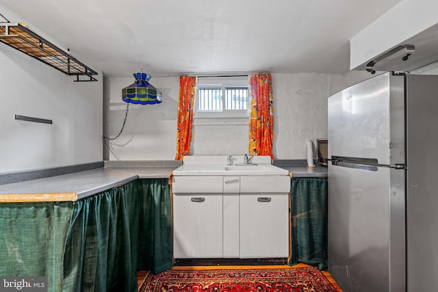 503 N Paca St, Baltimore, MD 21201 - kitchen with freestanding refrigerator, a sink, and white cabinetry