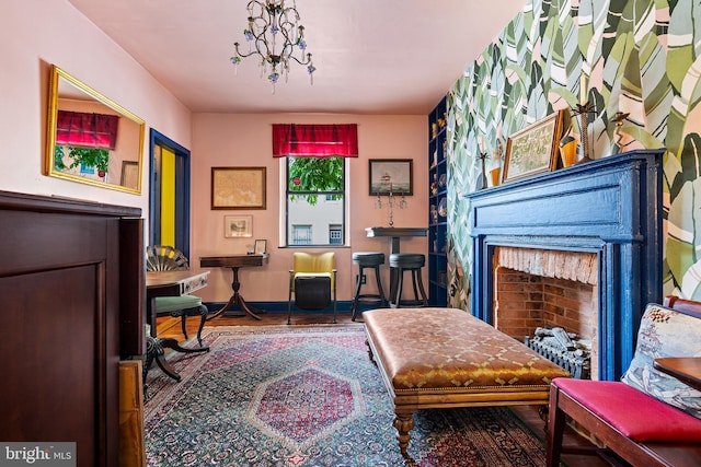 503 N Paca St, Baltimore, MD 21201 - sitting room featuring a fireplace, baseboards, and wood finished floors