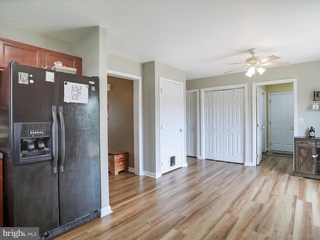 112 Toulouse Ln, Martinsburg, WV 25403 - kitchen with black refrigerator with ice dispenser, ceiling fan, light wood-style floors, and baseboards