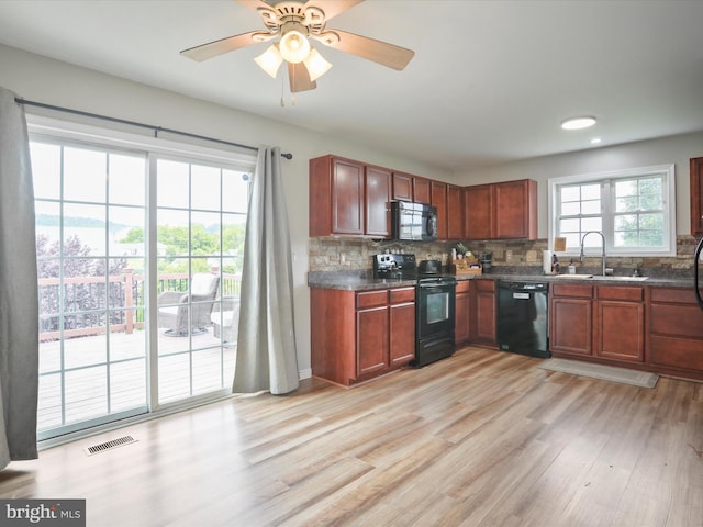 112 Toulouse Ln, Martinsburg, WV 25403 - kitchen with black appliances, a sink, dark countertops, tasteful backsplash, and recessed lighting