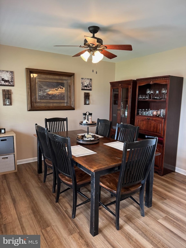 112 Toulouse Ln, Martinsburg, WV 25403 - dining area featuring light wood finished floors, a ceiling fan, and baseboards