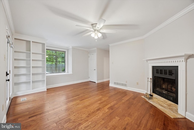 413 Eagle Rd # 7, Wayne, PA 19087 - unfurnished living room featuring a ceiling fan, a fireplace, wood finished floors, baseboards, and crown molding