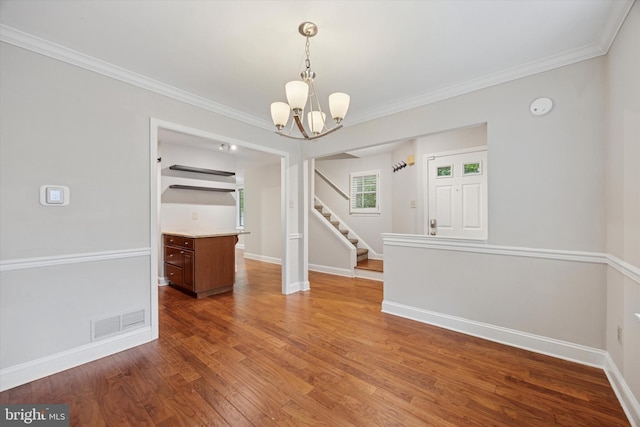 413 Eagle Rd # 7, Wayne, PA 19087 - unfurnished room with a chandelier, wood finished floors, stairway, crown molding, and baseboards