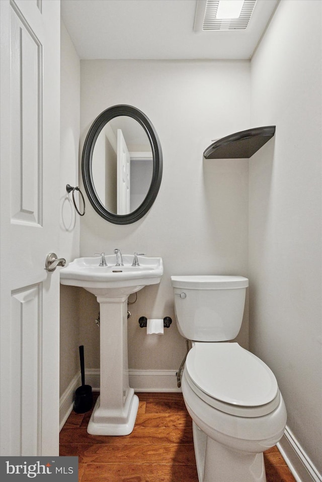 413 Eagle Rd # 7, Wayne, PA 19087 - bathroom with wood finished floors, toilet, baseboards, and a sink