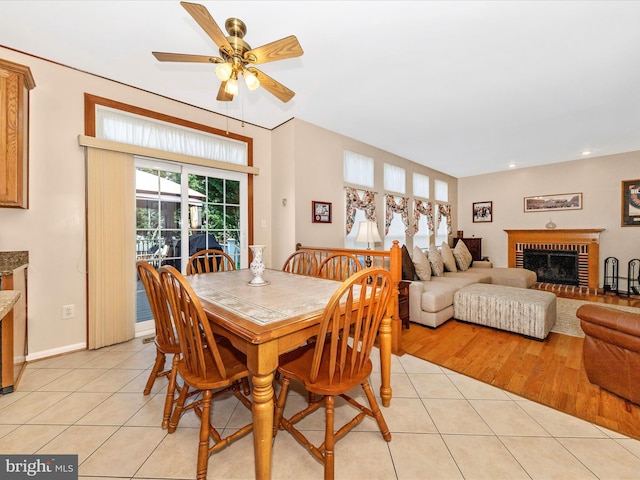 6810 Morrow Way, Frederick, MD 21703 - dining room with a fireplace, light tile patterned floors, a ceiling fan, recessed lighting, and baseboards