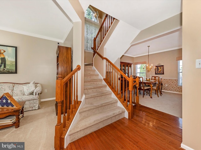 6810 Morrow Way, Frederick, MD 21703 - stairway featuring a chandelier, wood finished floors, carpet floors, baseboards, and crown molding
