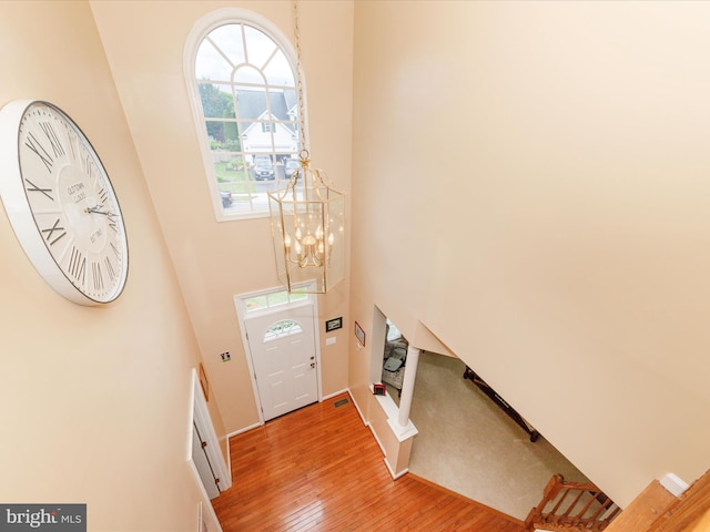 6810 Morrow Way, Frederick, MD 21703 - entryway with light wood finished floors, a towering ceiling, and a chandelier