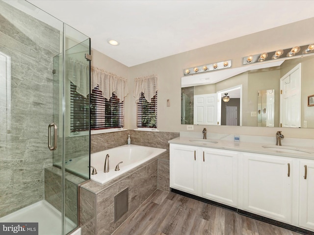 6810 Morrow Way, Frederick, MD 21703 - full bath featuring a garden tub, double vanity, a shower stall, and wood finished floors